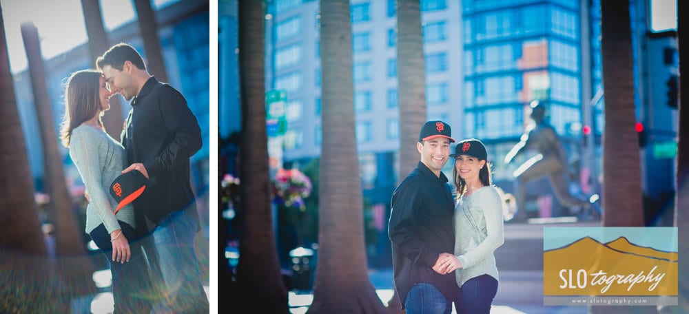 engaged couple wearing giants hats and willie mays statue