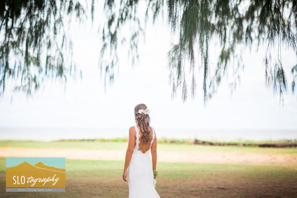 bride takes in ocean view under willow in kauai