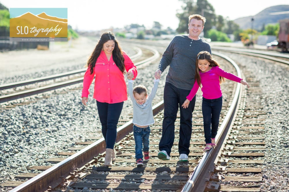 Family walking on the train tracks
