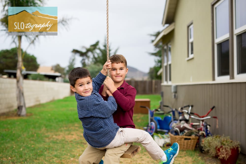 brothers on the swing in backyard