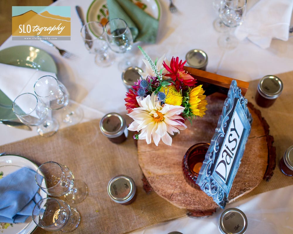 table decor with tree stumps and bright floral arrangement canvas