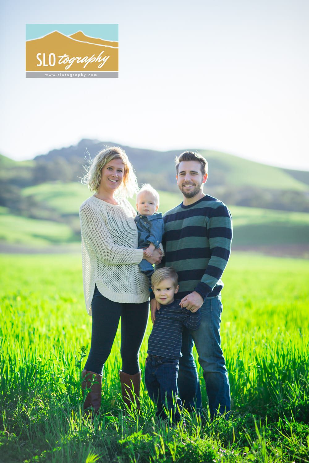 Family portrait in the green grass central coast