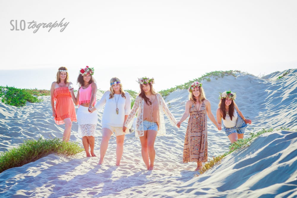 Bridal Party Holds Hands in Sand